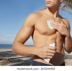 Man Putting Sunblock Sun Screen Cream On The Beach