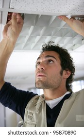Man putting up a suspended ceiling