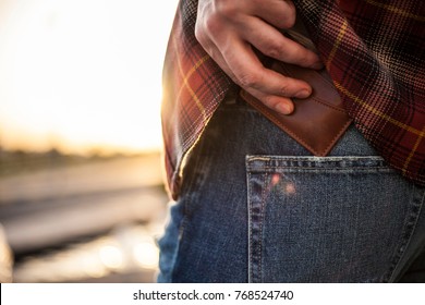 Man Putting Wallet In His Back Pocket