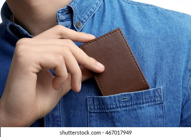 Man Putting Wallet In Shirt Pocket, Closeup