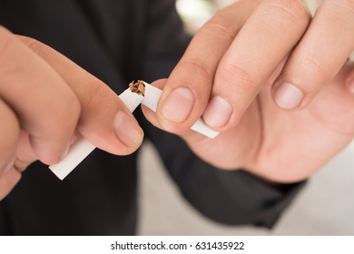 man quit smoking, breaking cigarette, concept of healthy lifestyle decision - Shutterstock ID 631435922