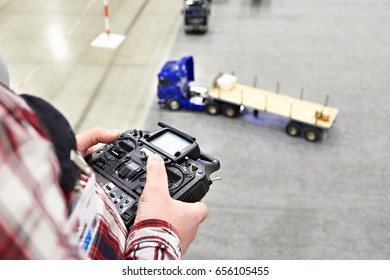 Man With Radio Remote Control And Truck Model Indoors