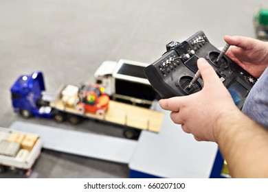 Man With Radio Remote Control And Truck Model Indoors