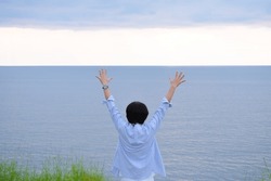 A Man Raise Up His Hand Or Open Arms Standing On The Beach