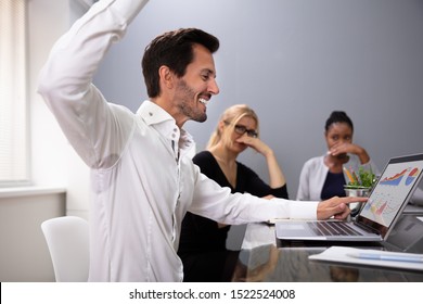 Man Raising Arm With Sweaty Armpit At Office Meeting