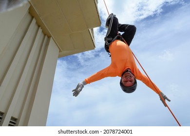 A man rappelling down the Lacerda Elevator. City of Salvador, Bahia, Brazil.