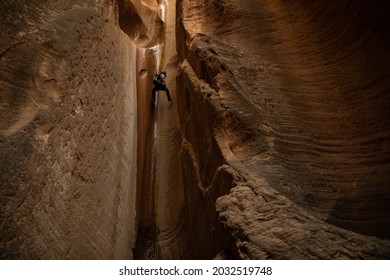 Man Rappelling In Utah Slot Canyon