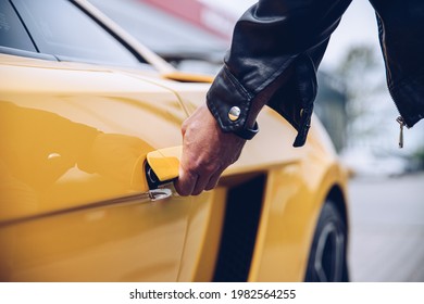 Man Is Reaching For The Car Door Handle