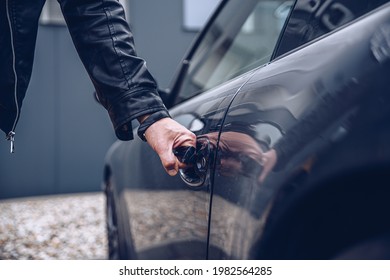 Man Is Reaching For The Car Door Handle