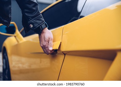 Man Is Reaching For The Car Door Handle