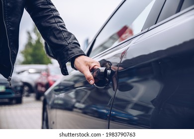 Man Is Reaching For The Car Door Handle