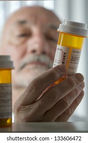 Man Reaching For Prescription Form Medicine Cabinet