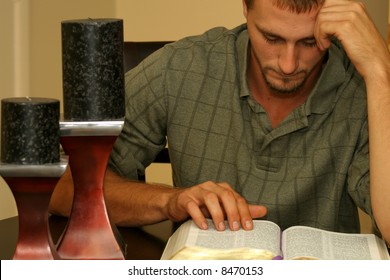 Man Reading The Bible W/candles