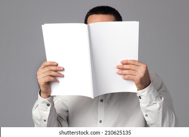 Man Reading A Blank Magazine 