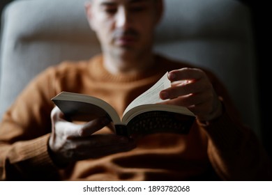 Man Reading Book At Home