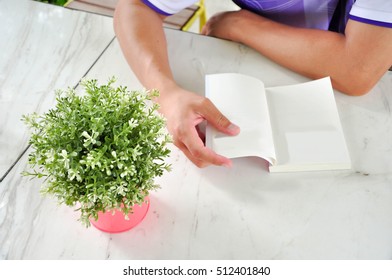 A man is reading a book for knowledge. reading a book. Men learn by reading the book.