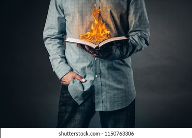Man reading a book on fire. Reading concept.