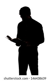 Man Reading A Book In Silhouette And Isolated On White Background