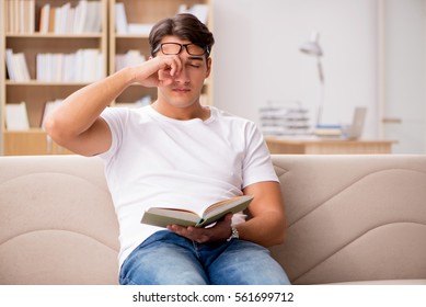 Man Reading Book Sitting In Couch Sofa