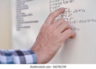 Man Reading The Braille Plate