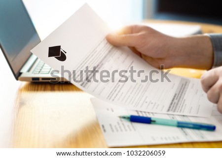 Man reading college or university application or document from school. College acceptance letter or student loan paper. Applicant filling form or planning studies.