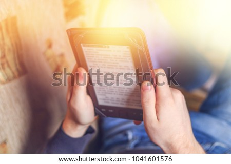 Man reading an e-book on digital tablet device