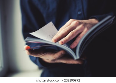 man reading a magazine - Shutterstock ID 232190992