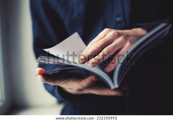 man reading a\
magazine