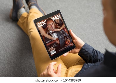 Man reading magazine on tablet