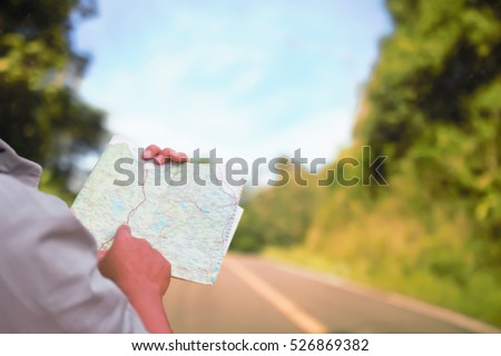 Man reading map soft blur for travel.