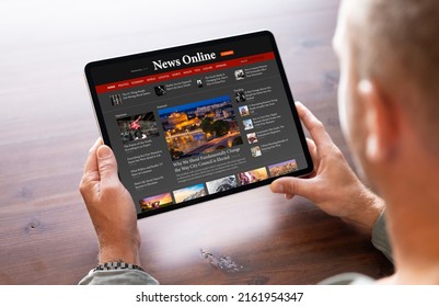 Man reading news on tablet computer