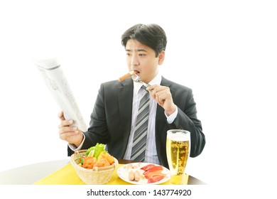 Man is reading newspaper and eating foods - Powered by Shutterstock