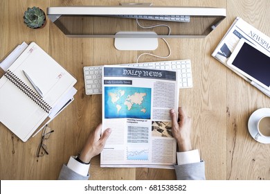 Man Reading Newspaper On Table