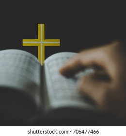 Man reading and praying over Bible - Shutterstock ID 705477466