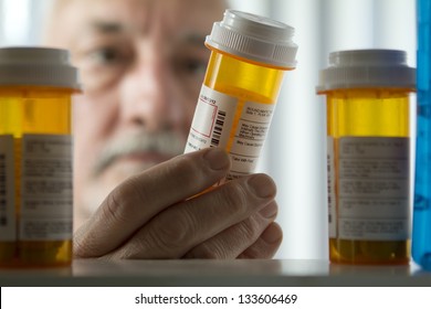 Man reading prescription bottle - Powered by Shutterstock