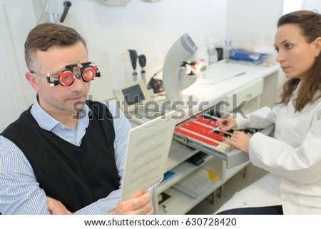 Man reading text while wearing optometrists glasses