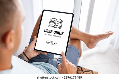 Man reading user guide on digital tablet