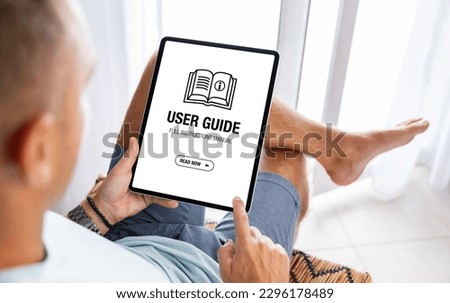 Man reading user guide on digital tablet