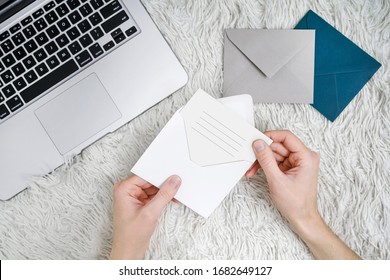 A Man Reads Letters While Lying On A Bed At A Laptop. Man Sends A Birthday Card