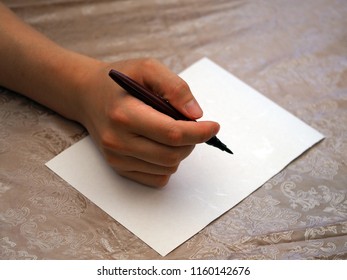 A man is ready to write on white paper