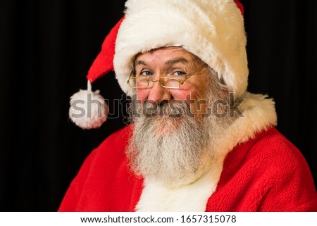 Man with real beard in Santa Claus dress