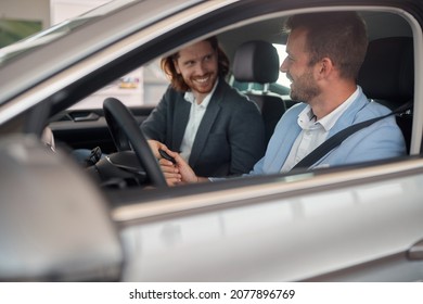 Man Receives The Keys To A New Car From A Sales Manager