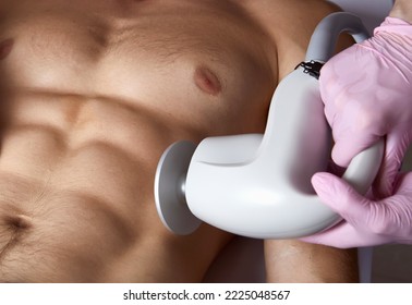 Man receiving fat reductive skin lifting body treatment on modern equipment at cosmetology clinic - Shutterstock ID 2225048567