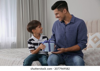 Man Receiving Gift For Father's Day From His Son At Home