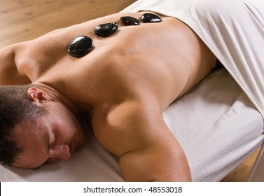 Man Receiving Hot Stone Therapy Massage