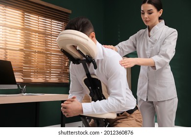 Man Receiving Massage In Modern Chair Indoors