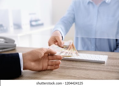 Man Receiving Money From Teller At Cash Department Window, Closeup