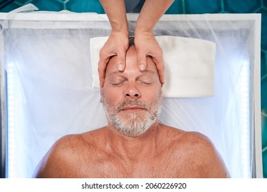 Man Receiving Professional Scalp Massage At Wellness Center