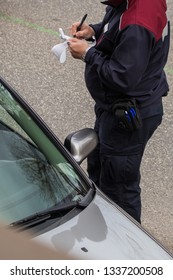 A Man Receiving A Speeding Ticket In An Urban Area By A City Ranger. Speeding Drivers Are Getting A Fine. View From Above. Car Stopped And Officer Standing Next To It.