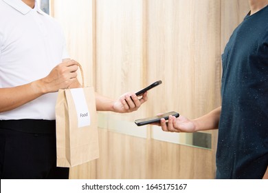 Man Recieve Food In Paper Bag Delivery Using Smartphone Scan Payment Digital Wallet.